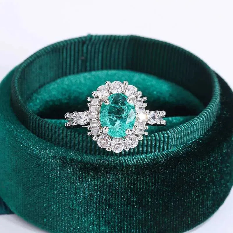 Timeless emerald and diamond halo cocktail ring in platinum.