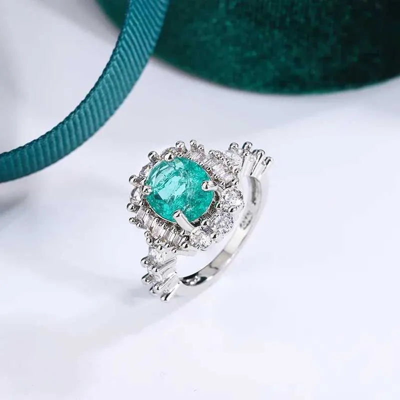 Timeless emerald and diamond halo cocktail ring in platinum.
